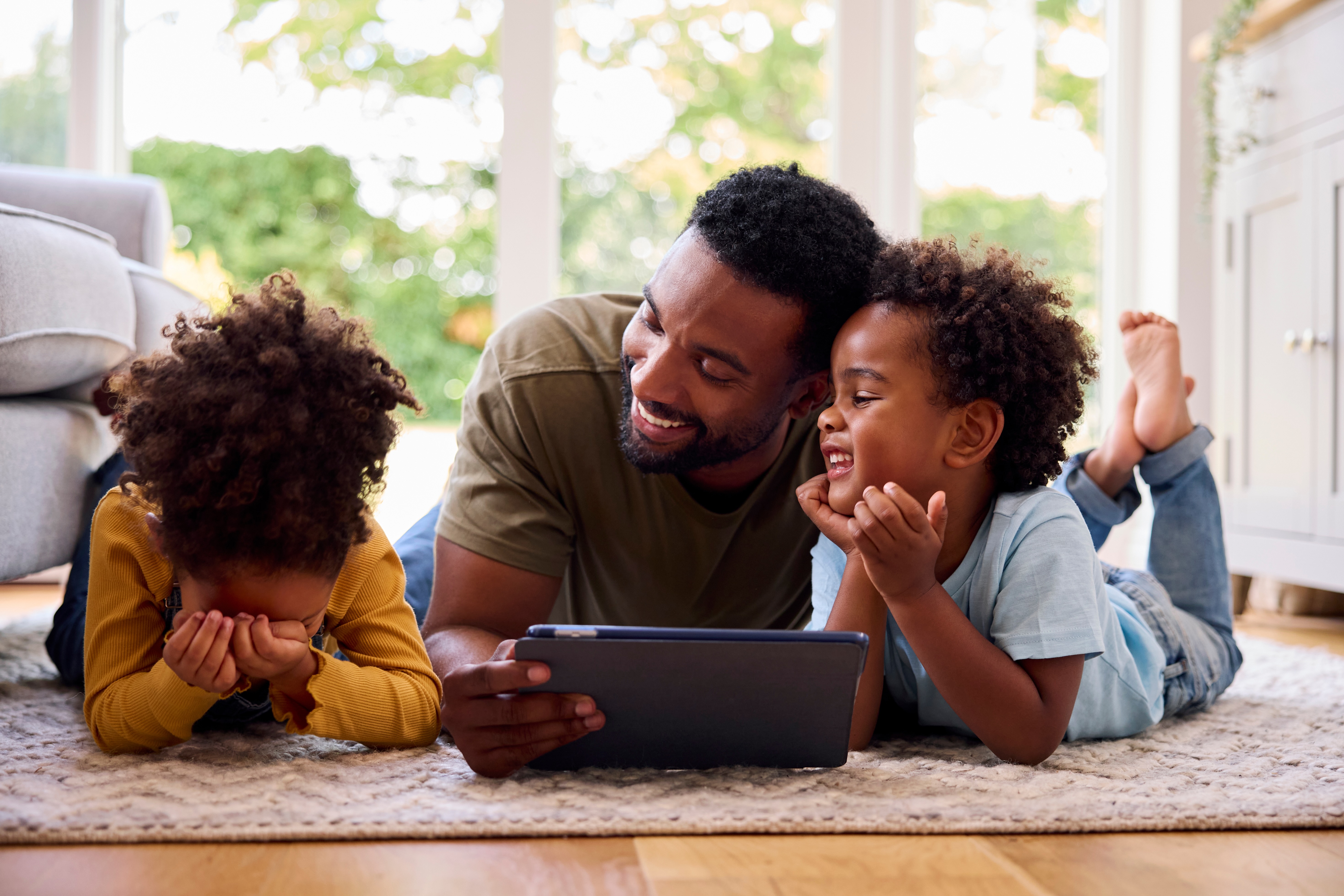 Father and children learning together on a tablet